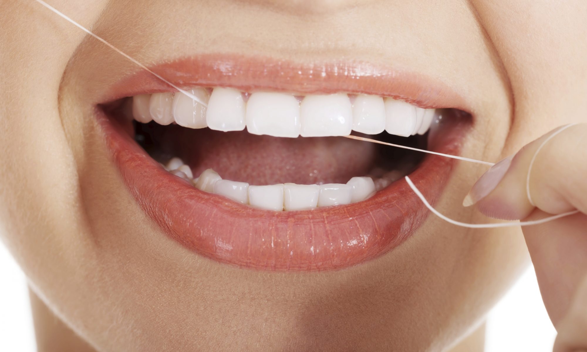 A woman flossing to show that flossing is an important aspect of oral care